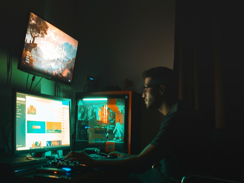 Editor writing notes beside a gaming monitor
